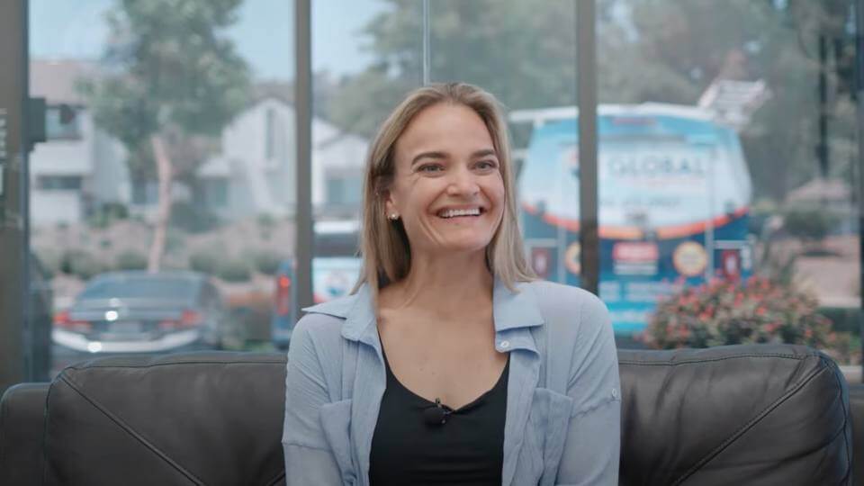 Smiling woman giving her video testimonial