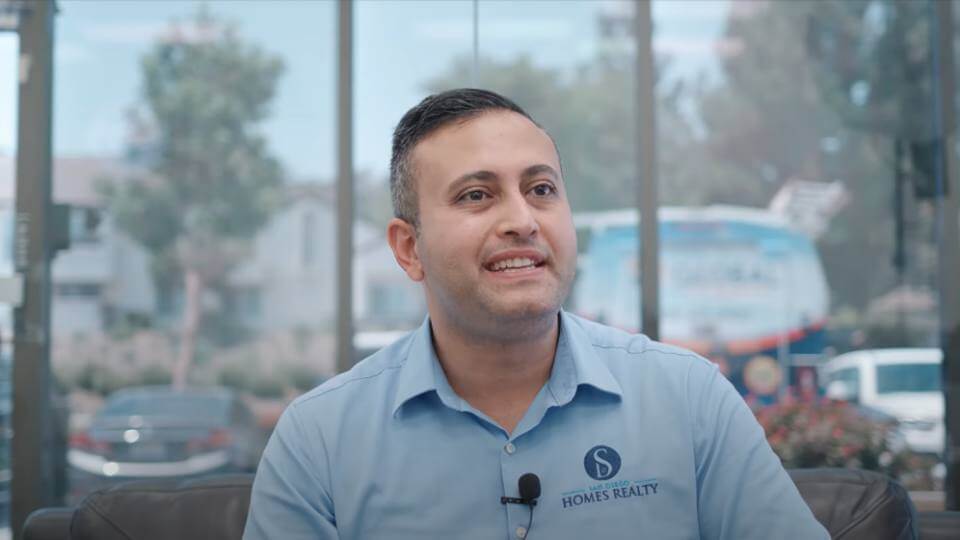 Smiling man in blue shirt giving his video testimonial